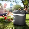 A portable cooler on a grassy lawn during a picnic with people in the background. Icons representing hot and cold temperatures are overlaid on the image. Podgląd zdjęcia produktu