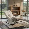 A rocking chair in a living room setting with a bookshelf and a side table. Produktbild-Vorschau