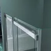 Close-up view of a shower door track and glass panel. Produktbild-Vorschau