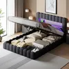 A bed with its storage compartment open, revealing various items stored inside. The bed has LED lighting in the headboard. Náhled obrázku produktu