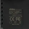 A close-up view of the label on a black AC/DC adapter. Produktbild-Vorschau