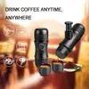 A portable espresso machine is shown with two small cups and coffee grounds, set against a blurred background. Produktbild-Vorschau