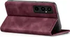 A burgundy flip cover case for a smartphone is shown from a diagonal angle, with the cover open to reveal the phone's camera array. Produktbild-Vorschau