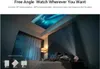 A couple is lying in bed watching a movie projected onto the ceiling by a small projector. Produktbild-Vorschau