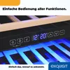 Close-up of a wine cooler's control panel with digital temperature display and buttons, illuminated by blue interior lights. Wooden shelves are visible above. Produktbild-Vorschau