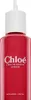 A close-up shot of a red perfume refill bottle with a white cap and dispenser. Produktbild-Vorschau
