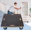 A man is pushing a cabinet on a transport roller in a room. Podgląd zdjęcia produktu