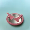 A pink ice cream maker with two pink spatulas on a light blue background. Podgląd zdjęcia produktu