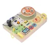 A wooden steering wheel toy for toddlers, designed to simulate a car dashboard with various interactive elements. Náhled obrázku produktu