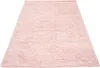 A pink shaggy rug shown from a diagonal, slightly elevated angle against a white background. Produktbild-Vorschau