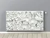 A white radiator cover with a floral leaf design is mounted on a light gray wall above a wooden floor. Voir les images du produit