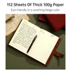 A notebook with a pen lying on it, with other notebooks and papers in the background. Náhľad obrázku produktu