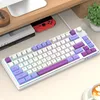 A white mechanical keyboard with colorful keycaps and RGB backlighting is placed on a desk. Produktbild-Vorschau