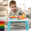A baby is playing with a colorful activity table in a living room. Podgląd zdjęcia produktu