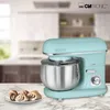 A mint green stand mixer is shown on a marble countertop with a plate of cinnamon rolls in front of it. The background is a blurred kitchen. Náhled obrázku produktu