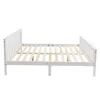A white wooden bed frame shown from a side-angle against a white background. Produktbild-Vorschau