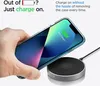 A hand is holding a clear phone case with a phone inside, placing it on a wireless charger. Podgląd zdjęcia produktu