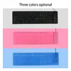 Three keyboards in different colors (black, pink, and blue) are displayed on separate colored backgrounds. Podgląd zdjęcia produktu