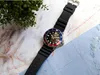 A watch is placed on a marble surface with a map and some greenery in the background. Produktbild-Vorschau