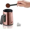 A hand is adding coffee grounds to a Turkish coffee pot. Produktbild-Vorschau
