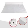 A roll of white material, likely fabric or paper, is laid out flat on a white surface. A close-up inset shows a rolled section of the material, revealing its texture and thickness. Náhľad obrázku produktu