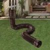 A brown flexible drain pipe is laid out on a green lawn in front of a house with a patio. Anteprima dell’immagine prodotto