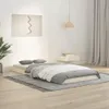 A minimalist bedroom scene with a bed, rug, and wall art. Náhled obrázku produktu