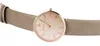 A close-up studio shot of a women's watch with a beige leather strap and a rose gold-colored face. Produktbild-Vorschau