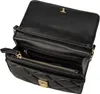 An open black quilted wallet with gold hardware. Produktbild-Vorschau