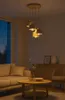 A modern living room with a sofa, coffee table, and a pendant light fixture. Produktbild-Vorschau