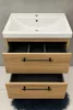 A bathroom vanity with a sink and drawers. Voir les images du produit
