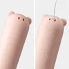 Two close-up shots of the top of a pink, bear-shaped object, likely a fan or similar gadget. The left image shows two dark dots for eyes. The right image shows a white string threaded through two small holes, suggesting it's being hung. Anteprima dell’immagine prodotto
