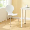 A white chair is placed next to a white table in a room with yellow walls and a window. Podgląd zdjęcia produktu