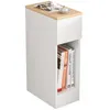 A narrow white bedside table with a wooden top, featuring a small drawer and an open shelf displaying several books. Produktbild-Vorschau