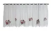A white lace curtain with embroidered Christmas figures. Produktbild-Vorschau