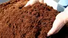 Hands holding a pile of brown soil. Produktbild-Vorschau