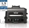A Ninja Woodfire Pro XL electric grill is shown on a reflective surface with a promotional badge on the left. Voir les images du produit