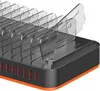 A close-up view of a black charging station with multiple clear dividers and orange accents. Náhľad obrázku produktu