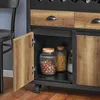 Close-up view of a kitchen island cabinet with an open door, revealing storage jars inside. Produktbild-Vorschau