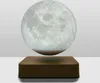 A levitating moon lamp sits on a wooden base against a plain background. Produktbild-Vorschau