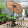 An outdoor patio set with a large umbrella, table, and chairs on a wooden deck. Voir les images du produit