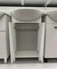 A white bathroom vanity with an open cabinet and a sink on top, displayed in a retail setting. Produktbild-Vorschau