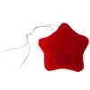 A red star-shaped ornament with two thin wires attached. Podgląd zdjęcia produktu