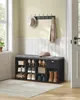 A shoe bench with storage compartments and a drawer, placed in an entryway with a hat and scarf on a wall rack. Náhled obrázku produktu