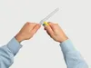 Hands holding a cable knife to cut a cable. Produktbild-Vorschau