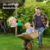 A father pushes his child in a wheelbarrow in a garden. Produktbild-Vorschau