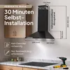 A black range hood is shown mounted above a kitchen counter with an induction cooktop. Dimensions and installation information are overlaid on the image. Produktbild-Vorschau