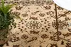 A close-up view of a beige rug with a floral pattern. Produktbild-Vorschau