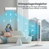 A woman sits on a couch in a living room, with a tower fan and an air conditioner visible. Produktbild-Vorschau