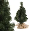A close-up view of a small artificial Christmas tree with a burlap base, shown next to a larger section of the same tree. Anteprima dell’immagine prodotto